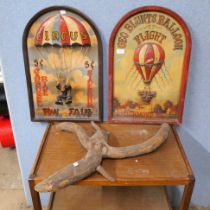 Two hot air balloon circus advertising signs and an abstract wooden art piece