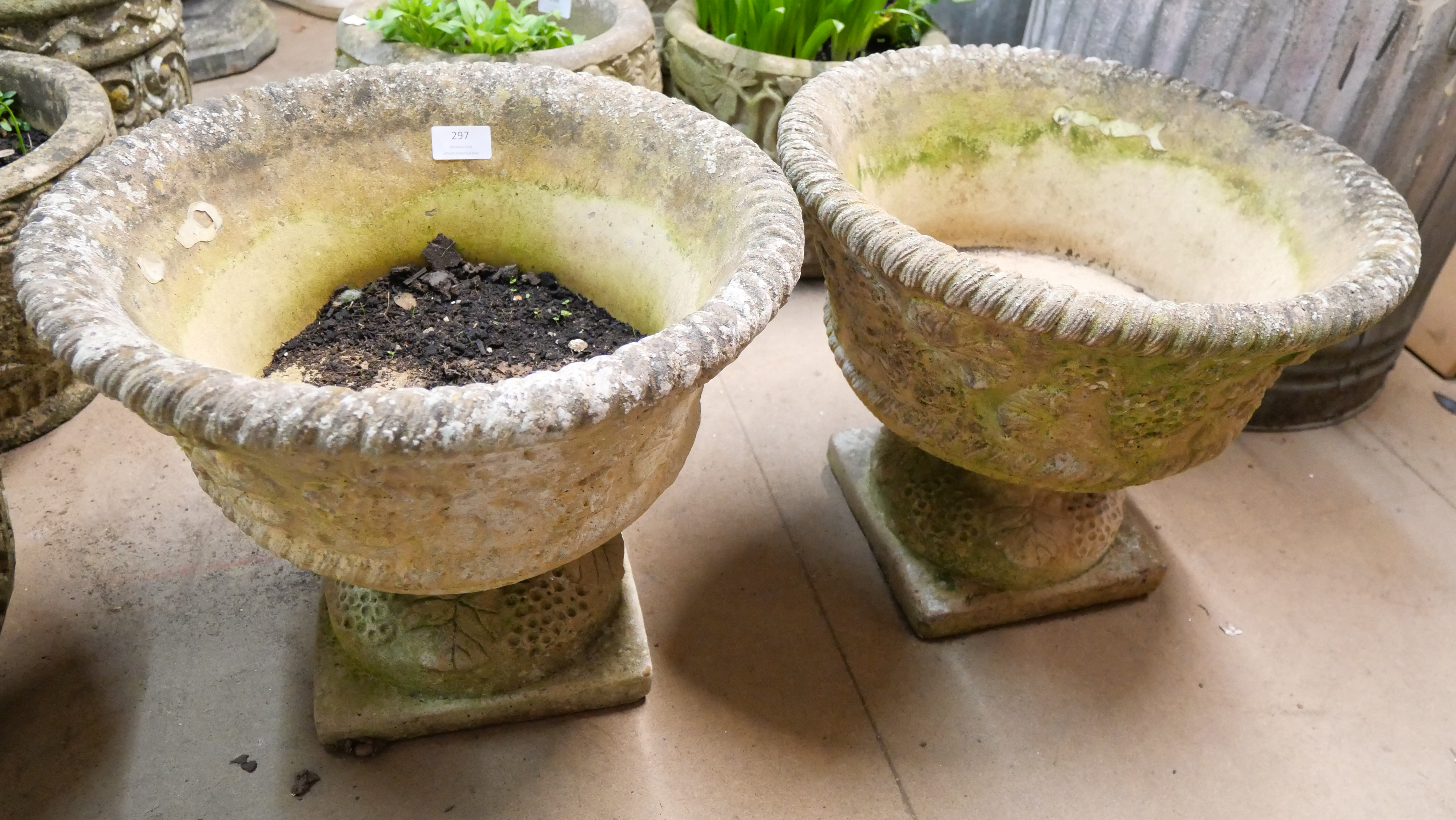 A pair of garden planters on stands