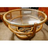 A circular bamboo and glass topped coffee table
