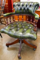 A mahogany and green leather revolving Captains desk chair