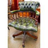 A mahogany and green leather revolving Captains desk chair