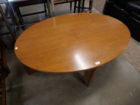 A teak oval coffee table