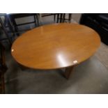 A teak oval coffee table