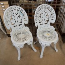 A pair of cast garden chairs
