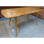 An Ercol Blonde elm and beech plank top Windsor dining table