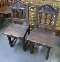 A pair of French carved oak hall chairs