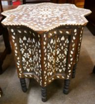 A Moorish carved wood and mother of pearl inlaid star shaped occasional table