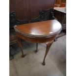 A Queen Anne style mahogany demi lune card table