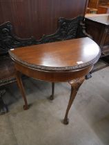 A Queen Anne style mahogany demi lune card table