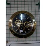 A gold coloured Rolex style dealers display wall clock