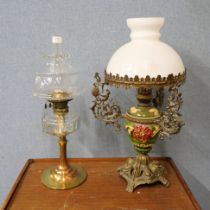 Two oil lamps, one clear glass with brass base and the other with opaque glass shade and ceramic and