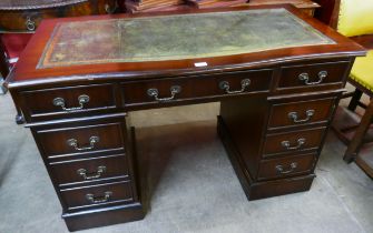 A mahogany leather top pedestal desk