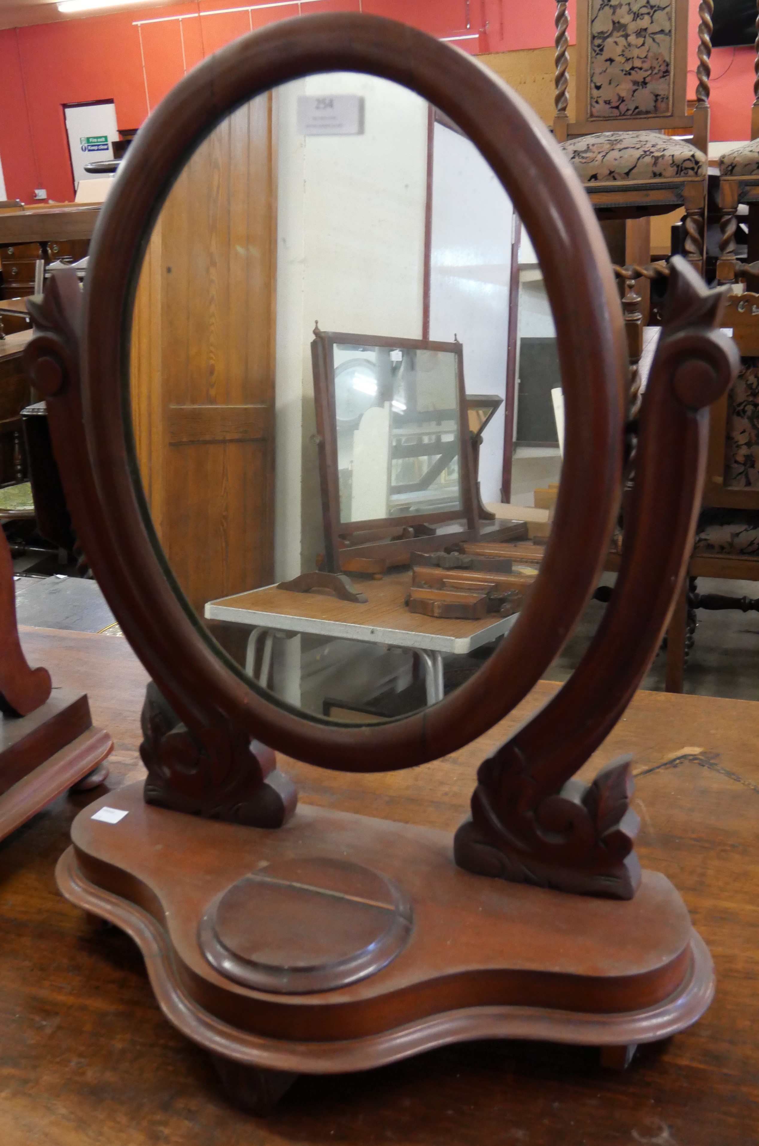 A mahogany toilet mirror