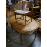 A Nathan teak extending dining table and three chairs