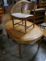 A Nathan teak extending dining table and three chairs