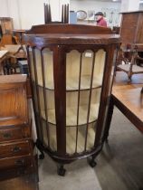 A mahogany bow front china cabinet