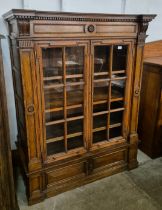 A Victorian Aesthetic Movement oak two door bookcase