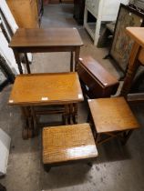 An oak nest of tables, small drop leaf occasional table and a side table and an oak stool