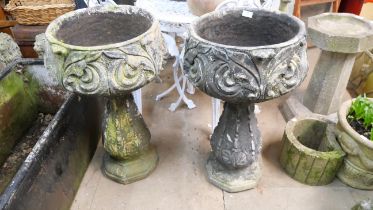 A pair of garden planters on stands