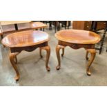 A pair of mahogany and walnut lamp tables