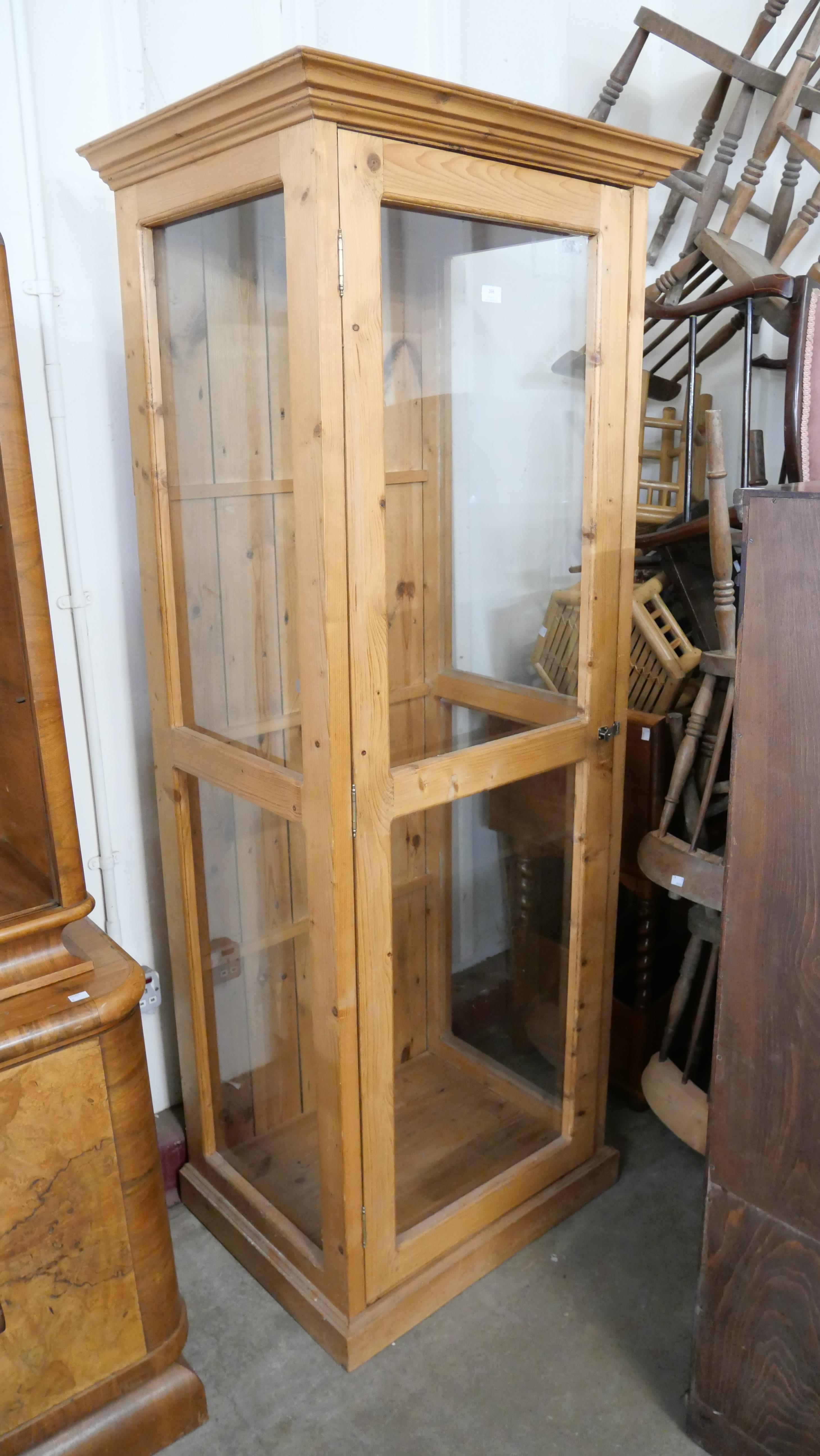 A pine glazed display cupboard