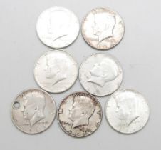 Seven 900. silver 1964 Liberty Kennedy half-dollar coins, 86.9g, one drilled
