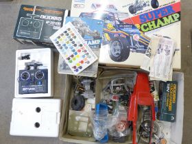 A 1980s Tamiya 1:10 radio control Off Roader Racer Super Champ, (built and disassembled) with an