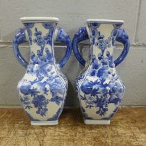 A pair of oriental blue and white two handled vases