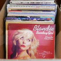 A box of 1980s punk, new wave and pop 7" singles including The Cure, Skids, Ian Dury, Blondie,