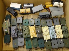 Ten model tanks on Tri-ang model rail transporters and a collection of wagons