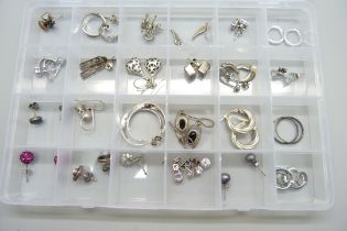 Twenty-four pairs of silver earrings