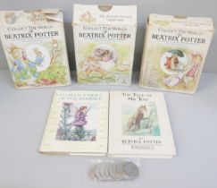 A collection of Beatrix Potter books and ten Beatrix Potter 50p coins