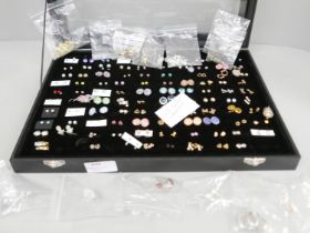 A jewellery display box with 113 pairs of earrings