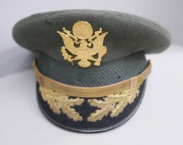 A US Military peaked cap belonging to Lt. Col. Theo C. Florey, WWII and Korea served, recipient of