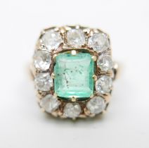 A 19th Century yellow metal set emerald and diamond cluster ring, approximately 1.2ct diamond