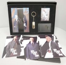 A James Bond No Time to Die postcard set and a gold plated key chain and postcard set, boxed