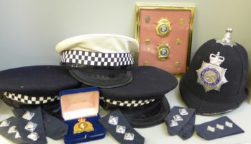 A collection of Police memorabilia; helmets, caps, lapel badges, shoulder flashes, etc.