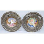 A pair of Limoges plates mounted in pierced cast metal circular frames, 25cm diameter, both plates