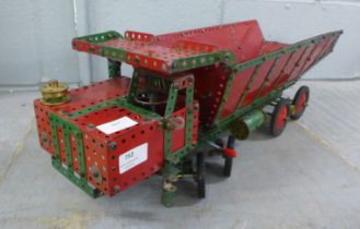 A 1950s red/green Meccano dumper truck with working steering and tipping body, 65cm