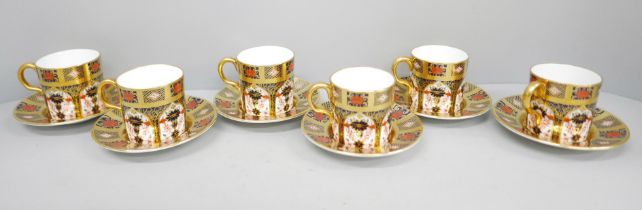 A set of six Royal Crown Derby 1128 coffee cans and saucers