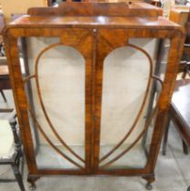 An Art Deco figured walnut display cabinet