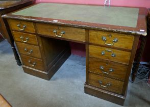 An Edwardian mahogany and leather topped desk