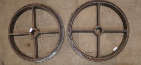 A pair of cast iron metal wheels