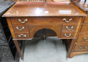 A George III inlaid mahogany five drawer writing table