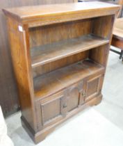 A carved oak open bookcase