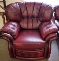 An oxblood red leather armchair