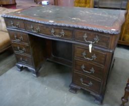 A Chippendale style mahogany and leather topped serpentine desk