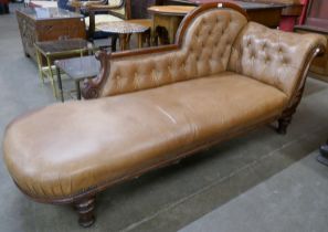 A Victorian beech and leather upholstered chaise longue