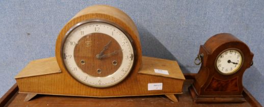 Two clocks; one eight day mantel clock with wooden inlay and bevelled glass face, and one vintage