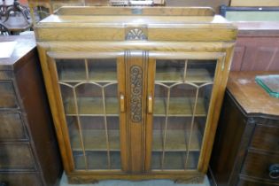 An early 20th Century carved oak bookcase